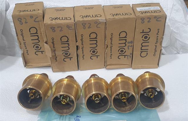 Five AMOT brass thermostatic valve elements with their original boxes